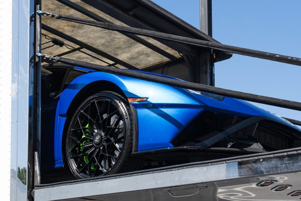 Cross country vs. in-state car shipping: a blue car being shipped.