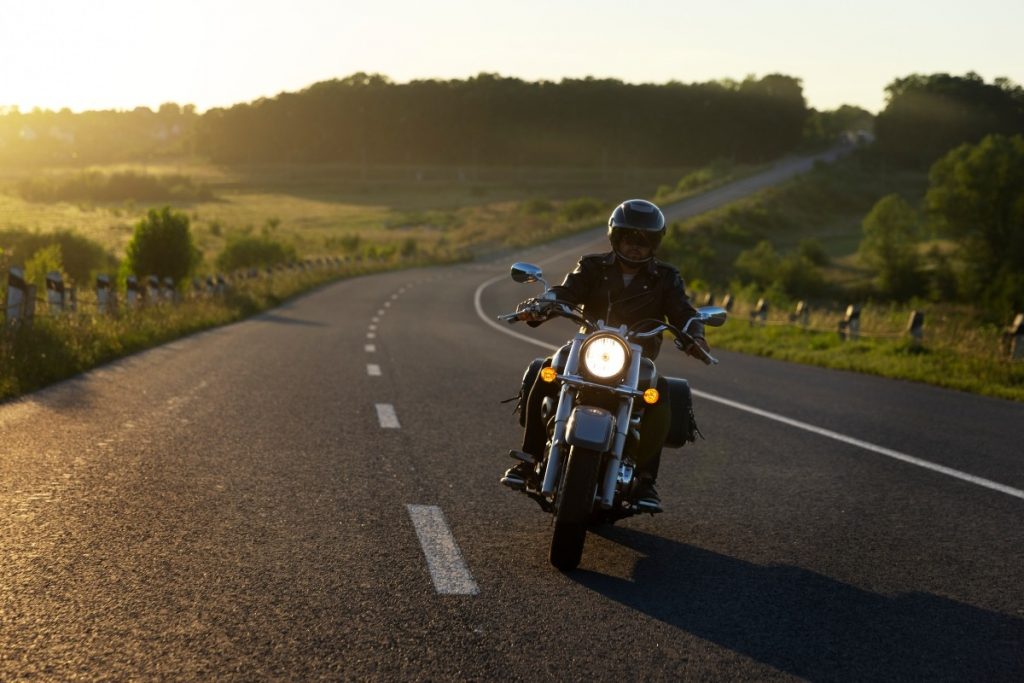 A motorcyclist on an open road.