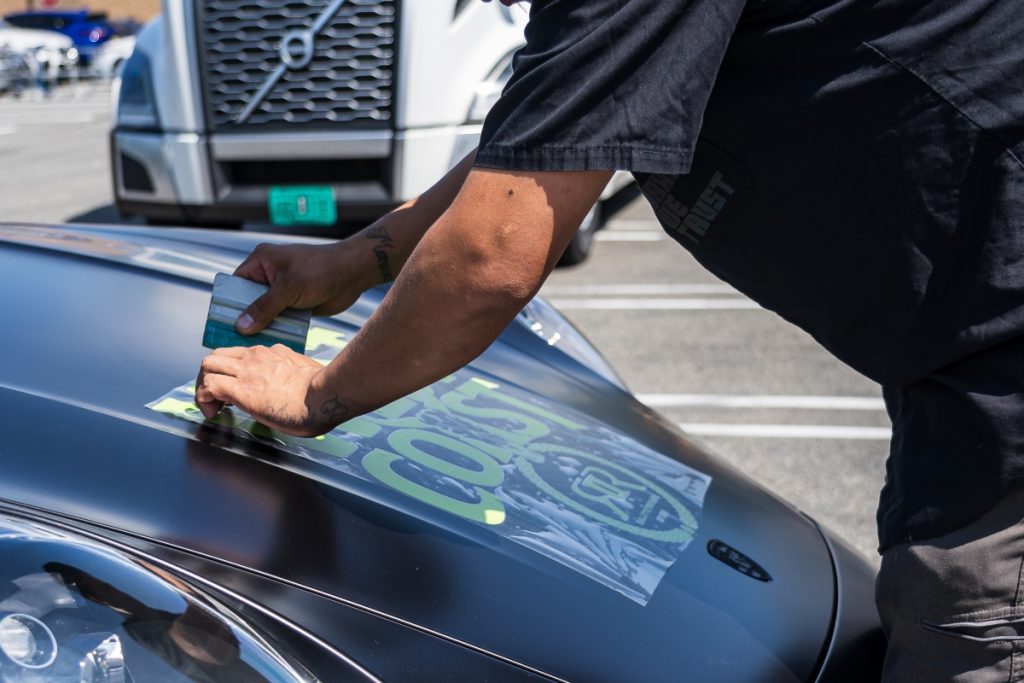 A Professional preparing a vehicle for seasonal car shipping.