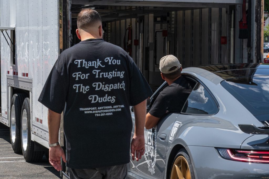 Dispatch Dudes preparing a car for enclosed transport.