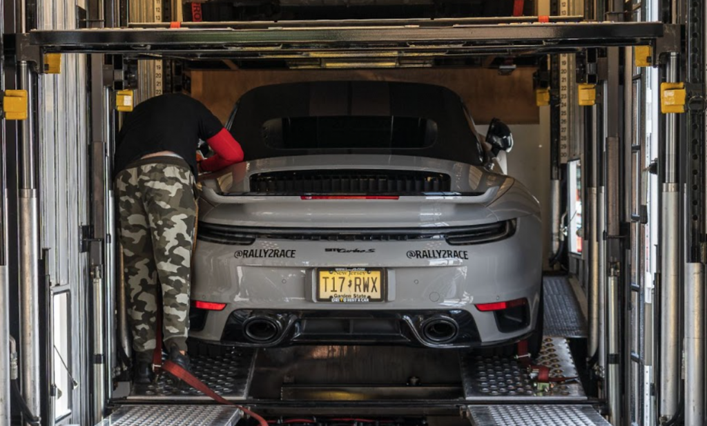 A man preparing a car for snowbird season shipping in Florida.