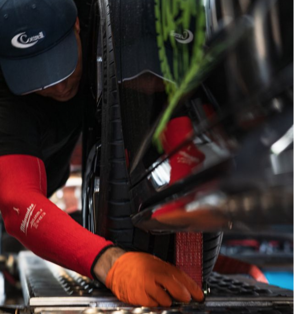 Professional auto transporter working on a car.