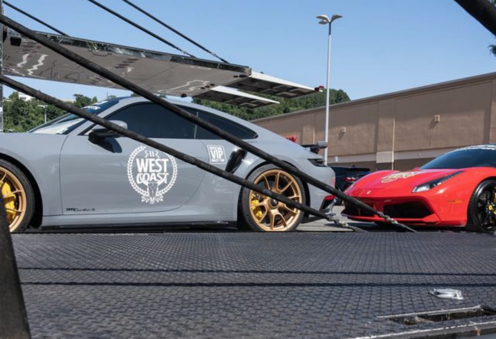 Multiple luxury cars being prepared for transport in California.