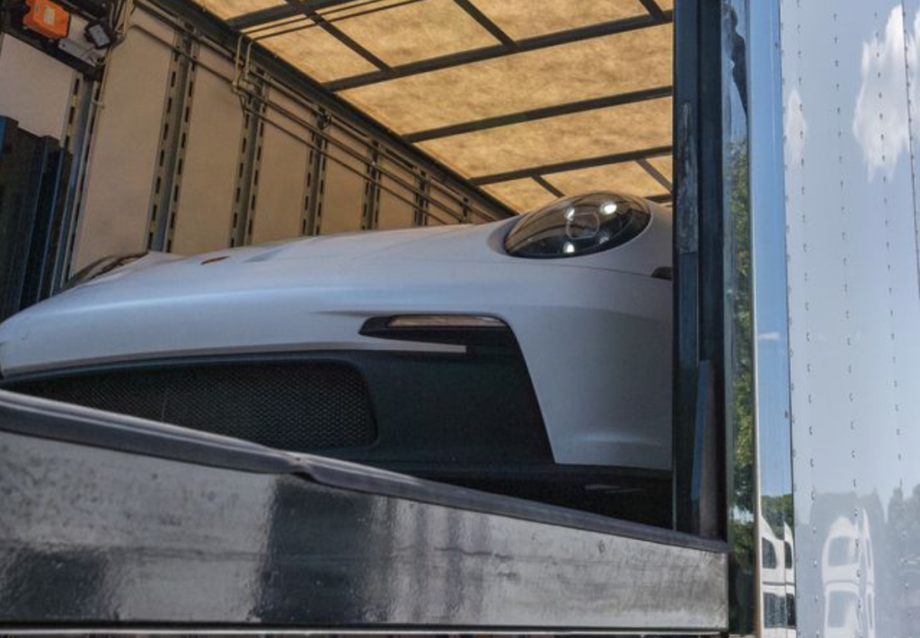 A Porsche supercar being loaded for transportation in Colorado.