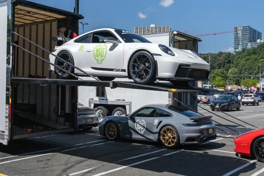 Sports cars being loaded for transport.