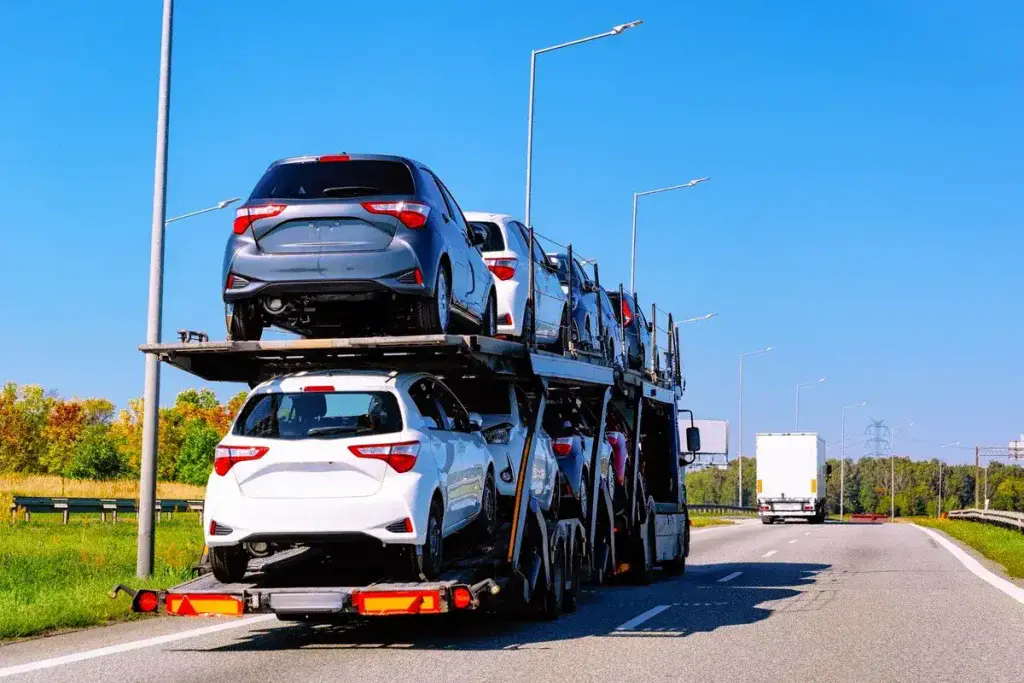 An open car carrier on a highway.